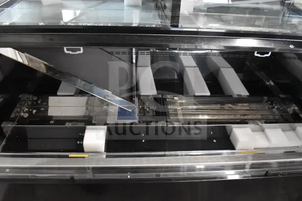 Brand new 2025 Avantco 193CAC60B air curtain merchandiser, black, 59 1/8", dual service, glass damage visible.
