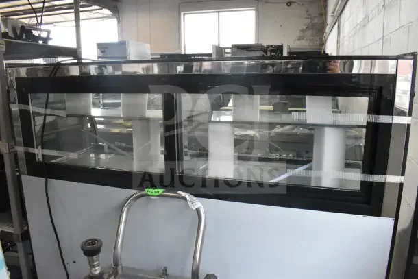 Avantco 193CAC60B commercial black curved refrigerated air curtain merchandiser, new with glass damage shown.