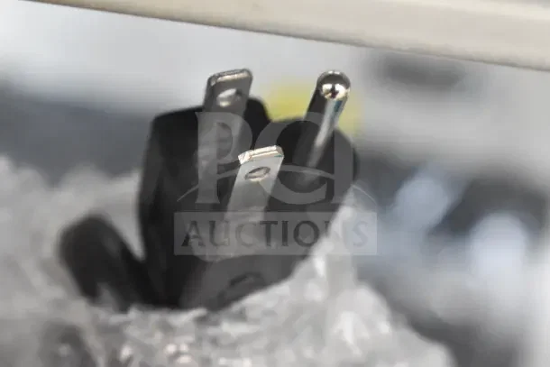Close-up of a power plug for a 2023 Avantco 177PG200S Panini Grill, wrapped in protective bubble wrap.