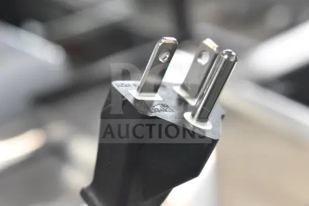 Close-up of a power plug for Avantco 177IC35SU induction range, showing prongs and embossed label with voltage details.