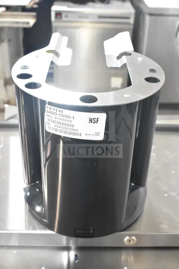 Brand new Fetco A150 black and stainless steel coffee server stand with NSF label and serial number visible. Scratch and dent condition.