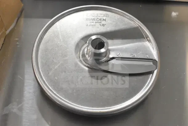 Stainless steel slicing plate labeled "Hallde Sweden 3 mm 1/8". New condition, suitable for Hobart slicers.