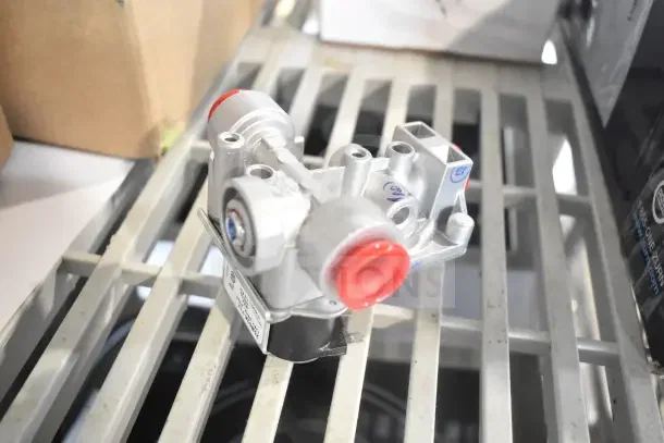 Vulcan 00-944391 4.0 Natural Gas Valve, new, silver with red cap, on metal rack. Includes tags and markings.