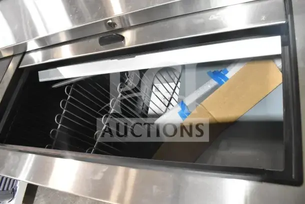 Brand new True TD-65-24-HC commercial back bar bottle cooler with two sliding lids, 115 volts, shown with interior racks.