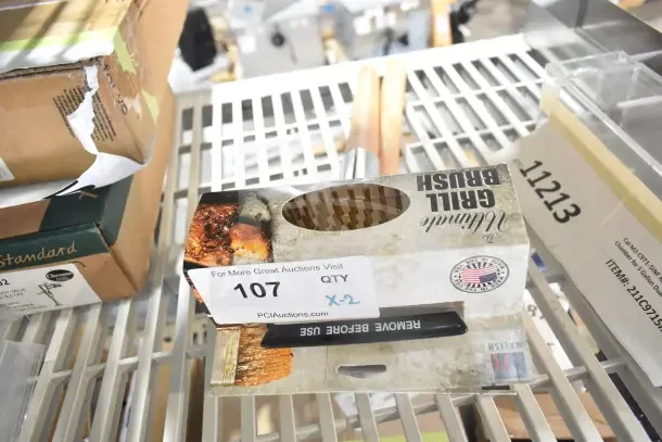 Two new Malish UGB Ultimate Grill Brushes in original packaging, slight box wear, tagged lot 107, USA made.