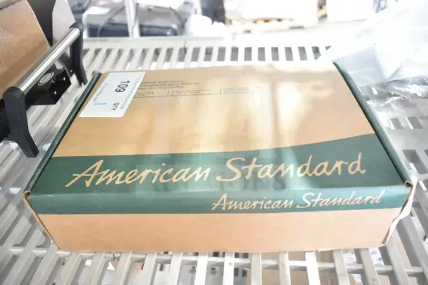 Brand new American Standard Ultima urinal flush valve, 0.5 GPF, model 6045051.002, in original packaging with slight damage.