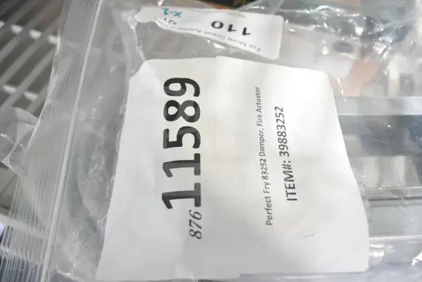 New scratch and dent Hobart 00-293408 stainless steel flex hose and Perfect Fry 83252 damper, fire actuator in packaging.