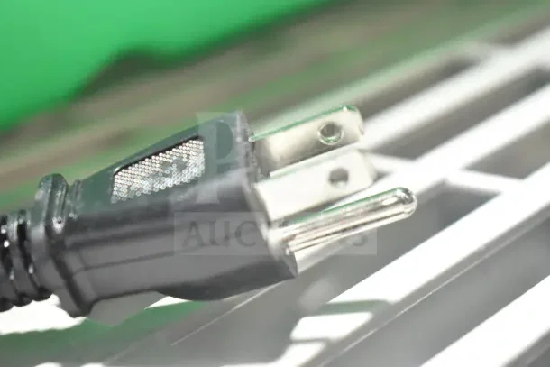 Close-up of a power plug for the Avantco CU45ETL coffee urn. Black plug with two metal prongs, showing electrical compatibility.