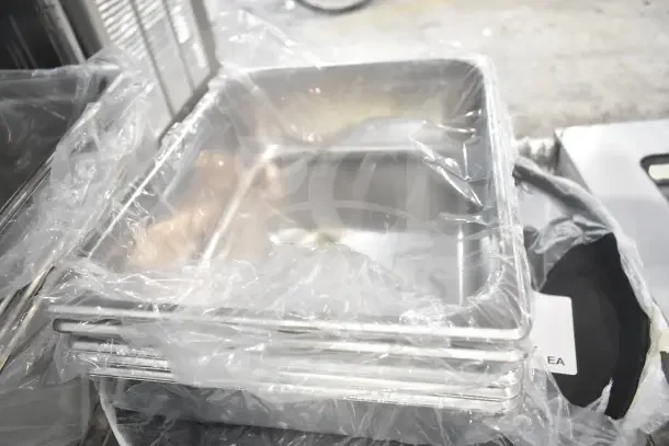 Seventeen brand new scratch and dent items, including stainless steel drop-in bins, in original packaging.