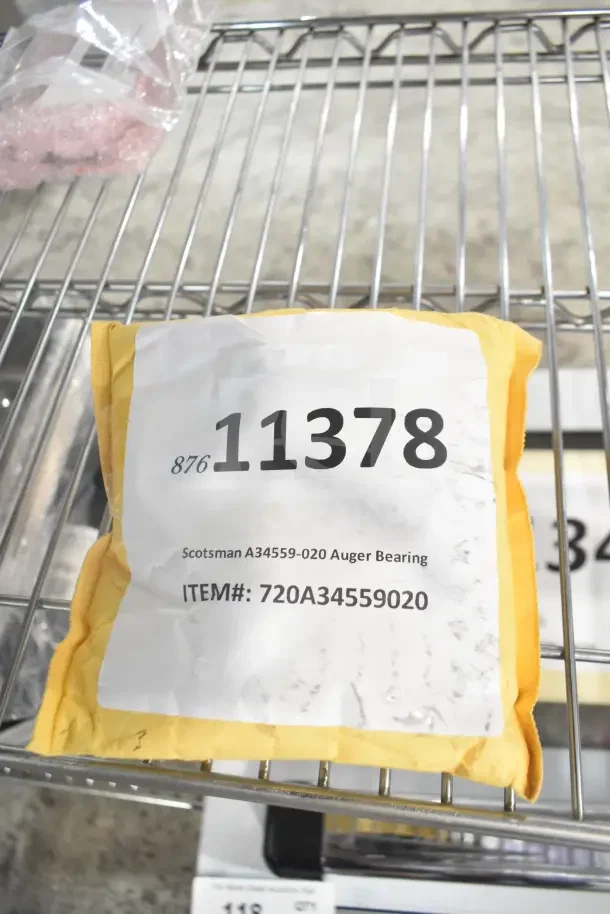 New Scotsman A34559-020 Auger Bearing in packaging, item #720A34559020, on metal shelf.