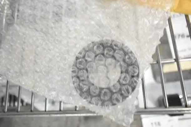 Bubble-wrapped Scotsman A34559-020 Auger Bearing, brand new, part of a 6-item scratch and dent auction lot.