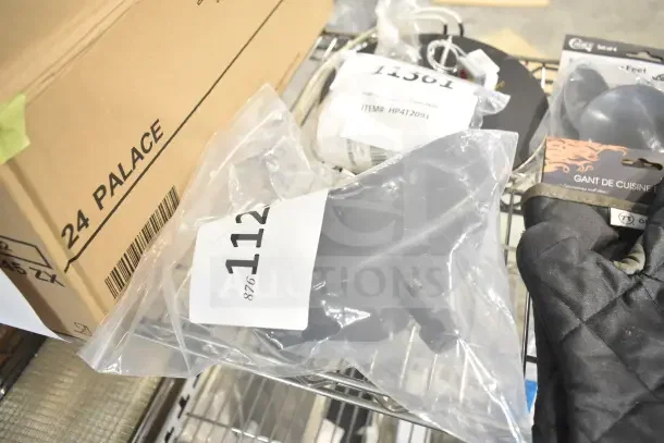 Assorted new scratch and dent auction items, including Lavex Zap N Trap UV bulb, Hobart sharpener, Southbend timer, Outset oven mitt, and suction cup feet.