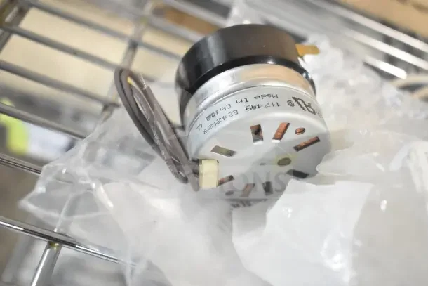 Hobart 00-479348 Sharpener Assy in new condition, shown in packaging. Markings indicate model and manufacturing details.