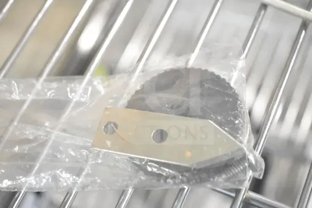 Clear plastic-wrapped Hobart 00-479348 Sharpener Assy on a metal rack, brand new, for auction.