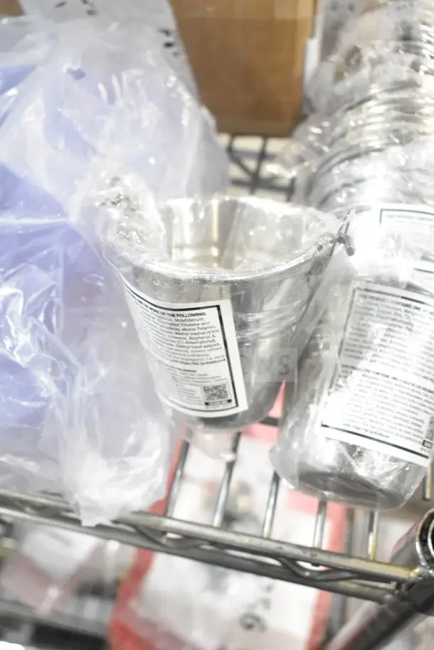 26 brand new scratch and dent items including metal buckets, wrapped, on a metal shelf with label holders.