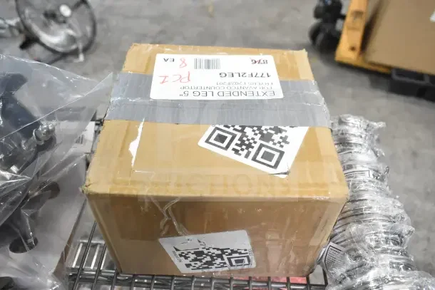 Box with label reading "EXTENDED LEG 5" for Avantco 177F2," alongside wrapped metal items and wrapped casters.