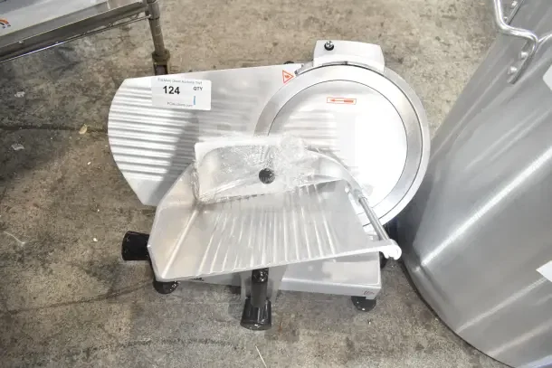 Brand new Backyard Pro 554SL112E 12" meat slicer with blade sharpener, 120V, 1 phase, minor scratches, protective wrap visible.