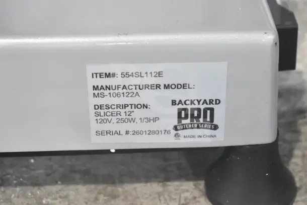 BRAND NEW Backyard Pro 554SL112E 12" Meat Slicer with Blade Sharpener. Scratch and dent. 120V, 1-phase, item tag visible.