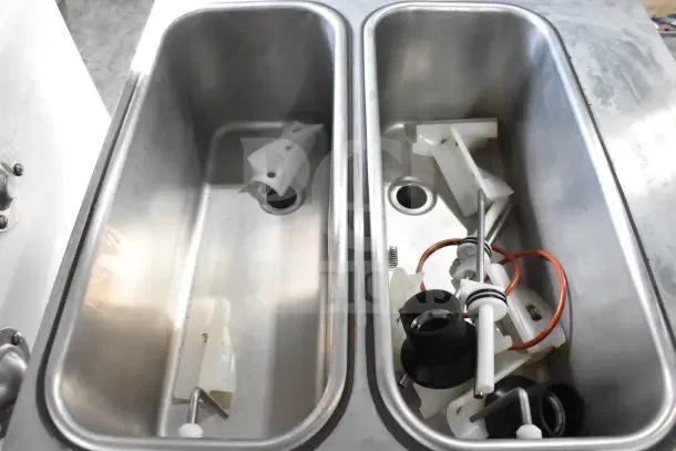 2024 Stoelting F131-38I2 soft serve ice cream machine internal components, showing clean stainless steel bins and accessories.