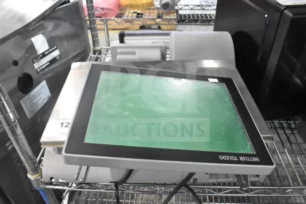 Mettler Toledo AM-5545 Commercial Countertop Scale in working condition on metal shelf; features digital touchscreen display.