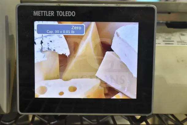 Mettler Toledo AM-5545 commercial countertop scale, tested and working, showing a display with cheese image.
