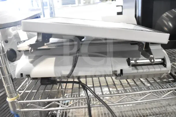 Mettler Toledo AM-5545 commercial countertop scale on metal shelf; tested and working condition, visible cords attached.