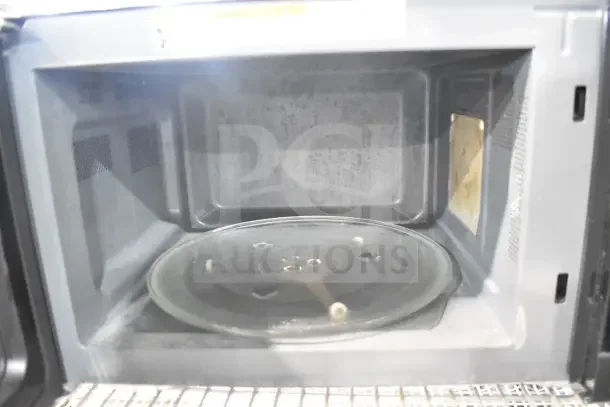 Hamilton Beach MS8436193153-03 countertop microwave, 120V, 1 phase. Interior view, used condition, glass turntable present.