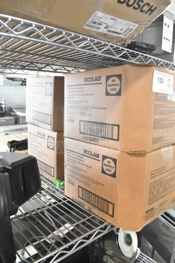 Ecolab Power Sink Detergent boxes on metal shelf; labeled 99 supply uses; includes sprayable glaze. Auction lot of 7 items.