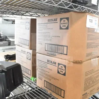 Ecolab Power Sink Detergent boxes on metal shelf; labeled 99 supply uses; includes sprayable glaze. Auction lot of 7 items.