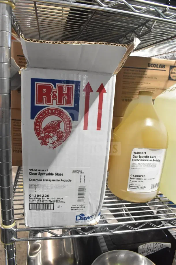 Box of R&H Clear Sprayable Glaze and Ecolab Power Sink Detergent on a metal shelf, featuring product labels and condition details.