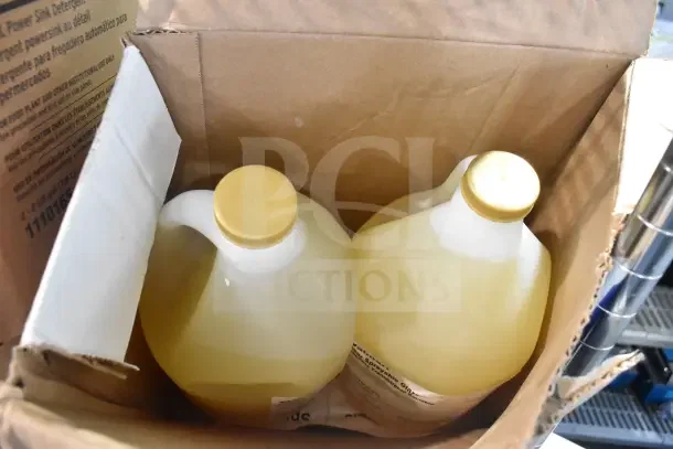 Box containing Ecolab Power Sink Detergent and Clear Sprayable Glaze, two yellow-capped jugs visible, new condition.