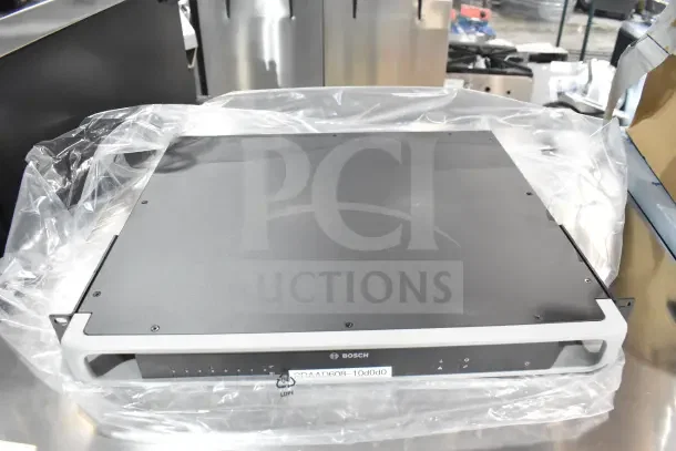 Bosch PRA-AD608 8 Channel Amplifier in new condition, covered with protective plastic. Model label visible on front panel.