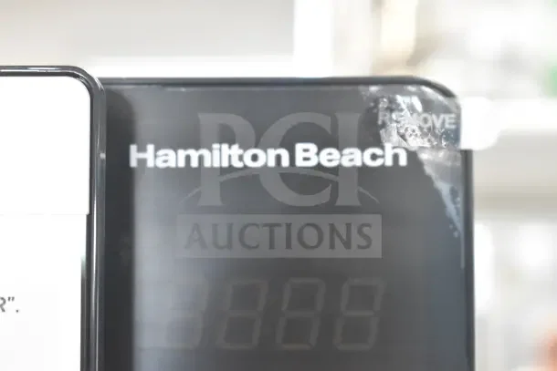 Hamilton Beach HB8436127995-01 Countertop Microwave Oven, 120 Volts, 1 Phase, visible branding and protective film.