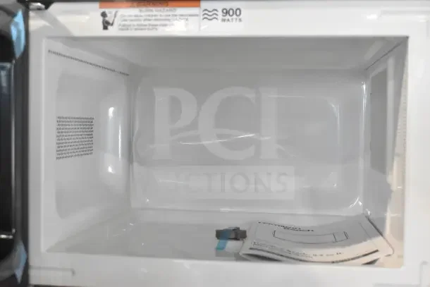 Hamilton Beach HB8436127995-01 microwave, 900 watts, 120 volts, 1 phase. Interior view, like-new condition, includes manual.