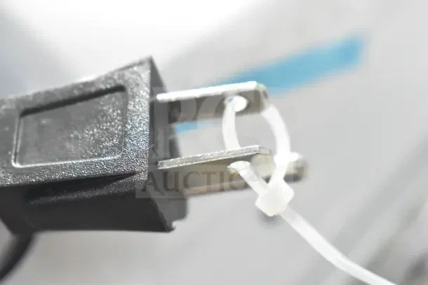 Close-up of a plug connected to the Hamilton Beach countertop microwave oven model HB8436127995-01, 120 volts.