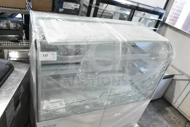 Avantco 193BC48HCW refrigerated bakery display case, white, curved glass with visible damage, 110-120V, 1 phase.