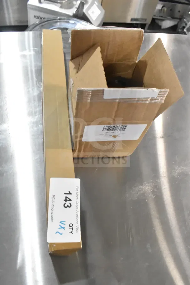Two brand new Delfield 2162667 fan motors in boxes, 115v/60hz, with metal legs. Includes "2 Times Your Bid" label.
