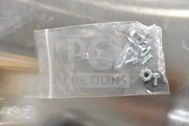 Plastic bag containing screws and nuts, likely for assembly. Part of Delfield fan motor set. Brand new, slight scratches.