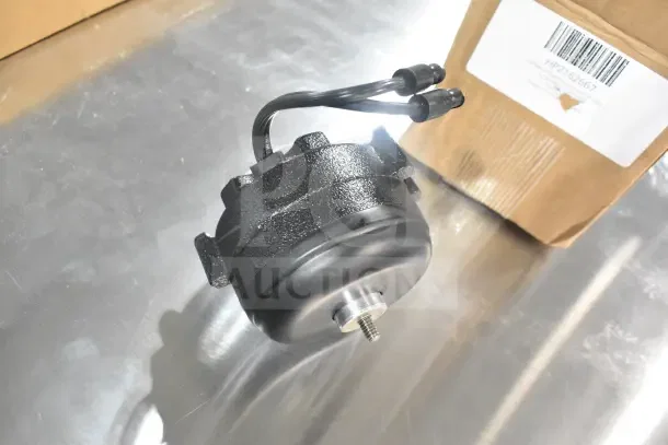 2 Delfield 2162667 fan motors, 115v/60hz, new with scratch and dent, shown with labeled boxes, metal legs included.