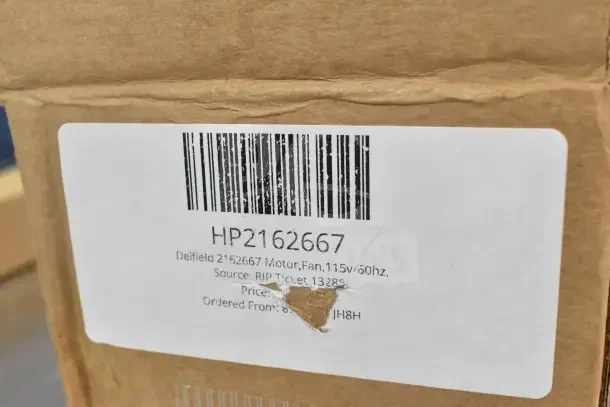 Cardboard box with label showing Delfield 2162667 Motor, Fan, 115v/60hz, HP2162667, scratch and dent condition.