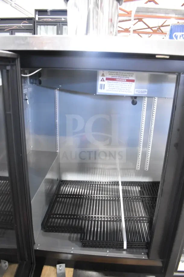 True TBB-2G-HC-LD commercial back bar cooler, brand new, scratch and dent, 2-door, 115V, interior with shelving, labels visible.