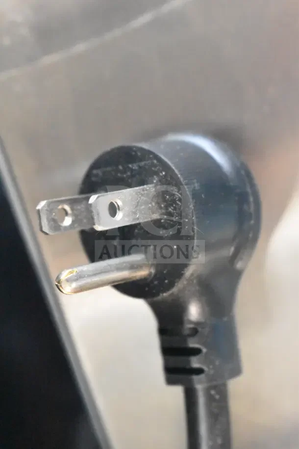 Close-up of a power plug for the True TBB-2G-HC-LD back bar cooler, showing a standard 115-volt plug.