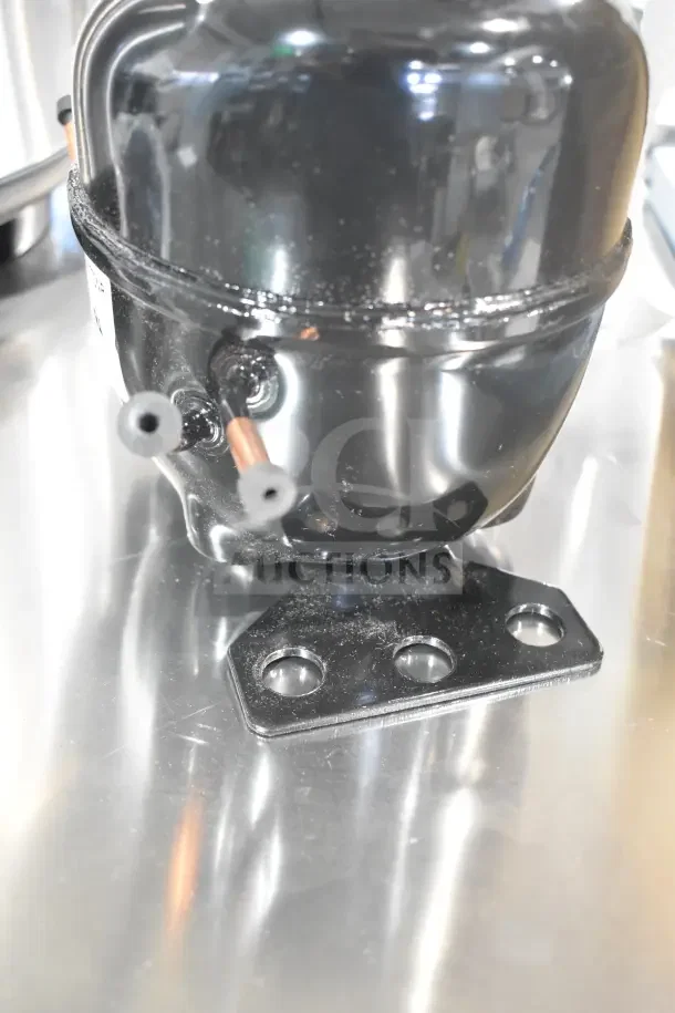 BRAND NEW Cubigel NUT70NR Avantco 17817638 Compressor, scratch and dent, black metal casing, mounting bracket visible.