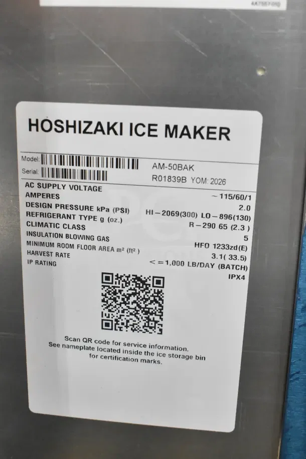 "New Hoshizaki AM-50BAK ice machine, 2026 model, 27 lb. bin, 54 lb. capacity, 115V, with a visible QR code for service info."