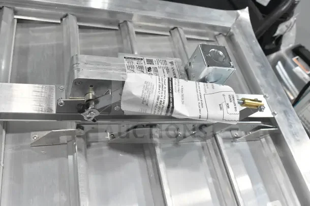 Brand new Canarm 3200 Series 20" x 20" motorized shutter backdraft damper, model SX3220X20, with label details visible.