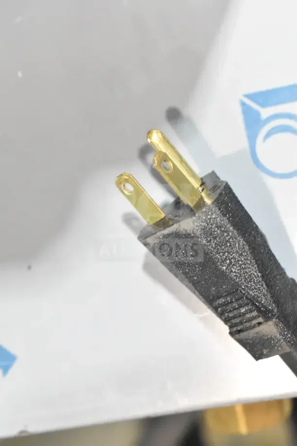 Close-up of a power plug for a 2026 Nemco 6310-3 Electric Countertop Hot Plate, 120V, 1 Phase, new with minor scratches.