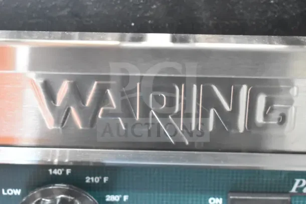 Brand new Waring WPG300 Panini Grill with grooved plates, 17"x9.25" area, 240V, model label visible.