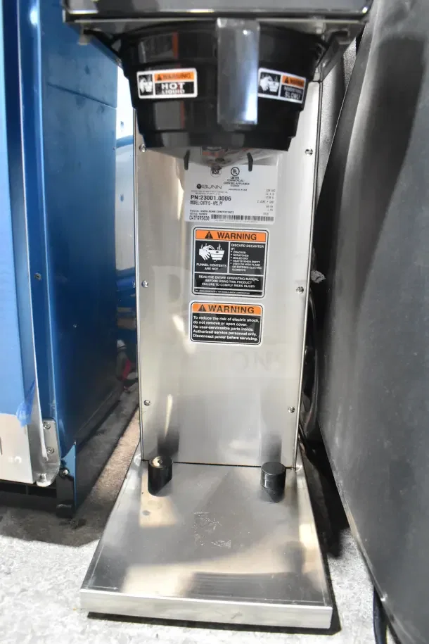 Brand new Bunn CWTF15-APS coffee brewer with hot water faucet, model 23001.0006, 120V, with warning labels visible.