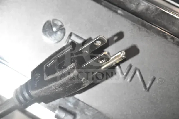 Close-up of a power plug for a new Bunn CWTF15-APS coffee brewer, showing the Bunn logo. 120 volts, 1 phase.