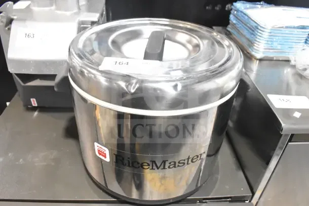 Brand new RiceMaster 56913S 96-cup sushi rice container, stainless steel finish, slight dents, visible label.